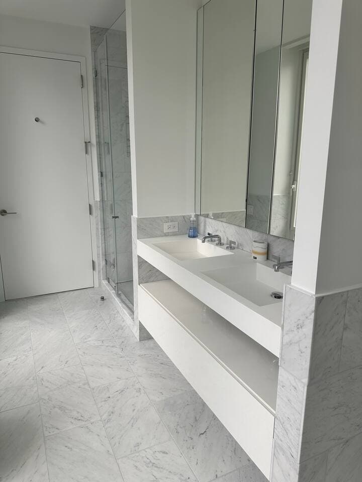 Jack and Jill bathroom connects the second and third bedrooms. Dual sink, shower, and toilet.