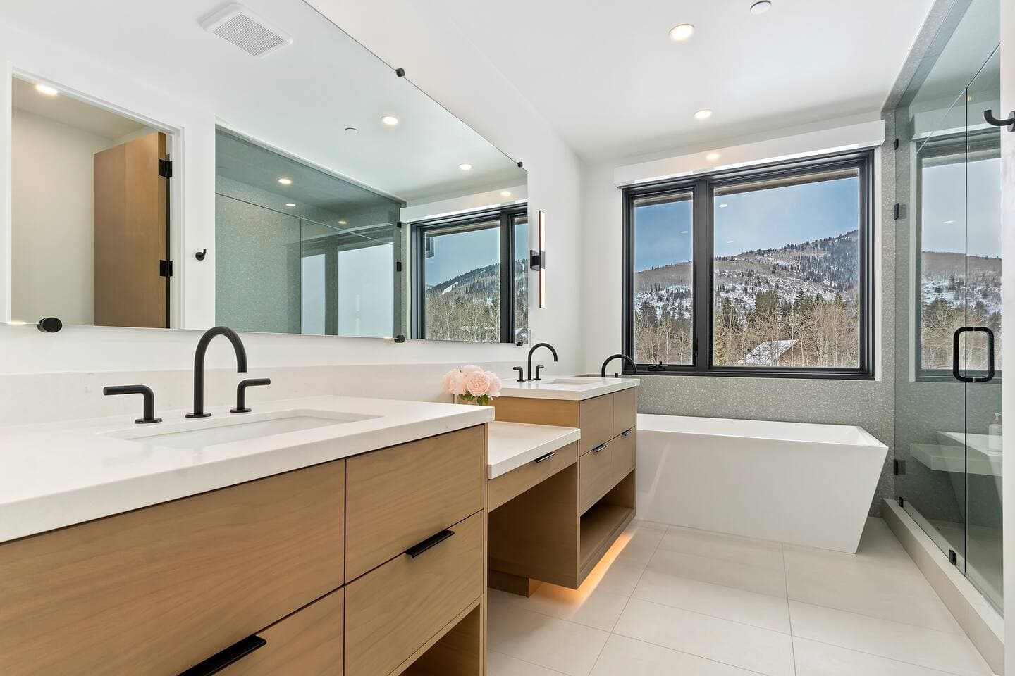 Primary Bathroom with heated floors, double vanity, bath tub, shower, and gorgeous mountain views.